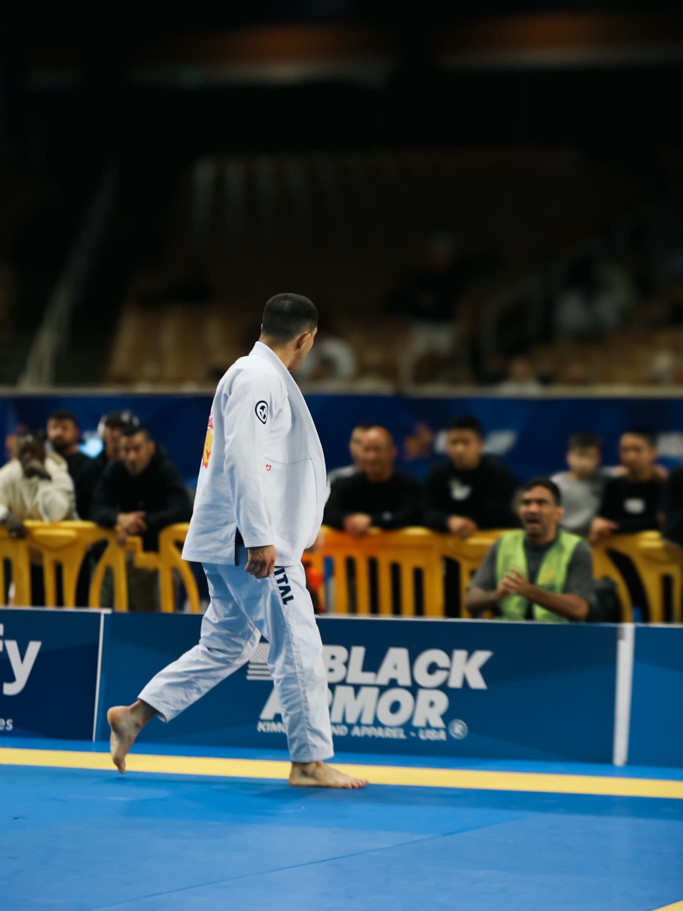 Athlete walking off the mat in front of the crowd